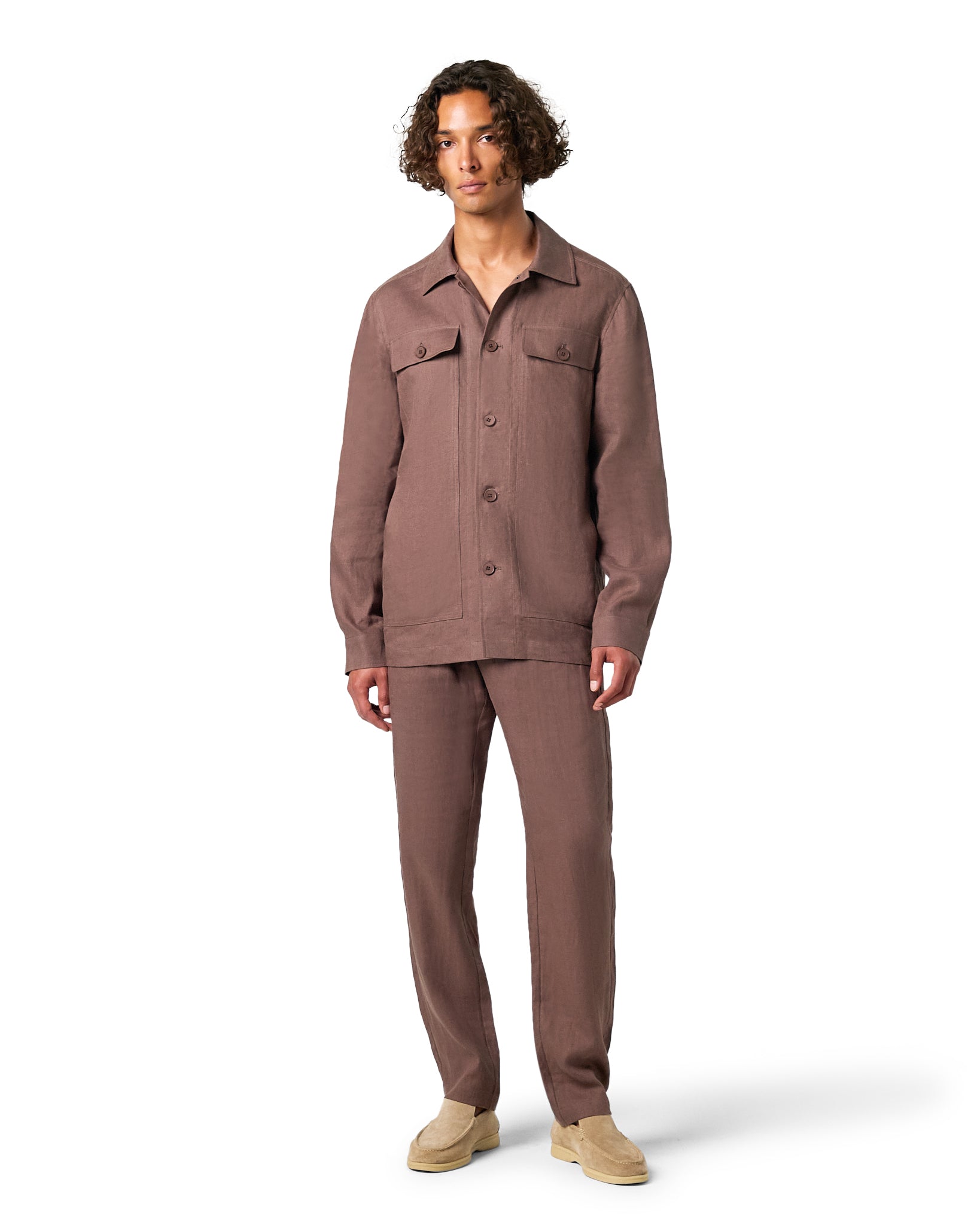 Man wearing a brown jumpsuit on a white background