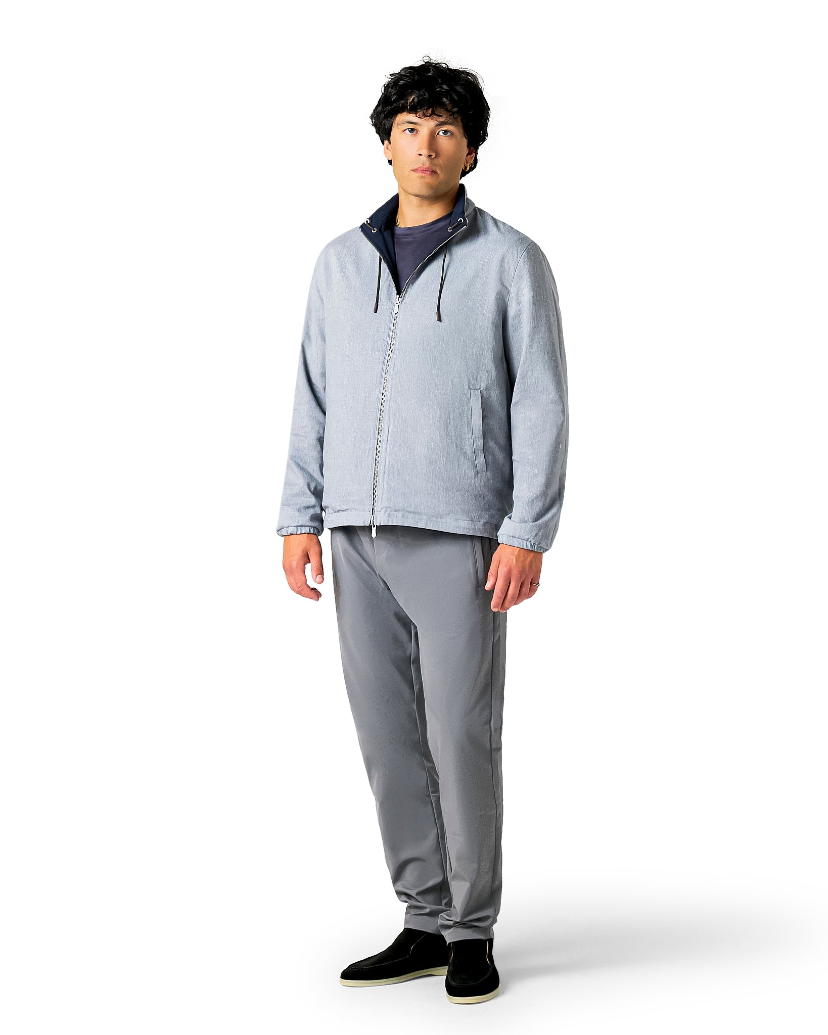 Man wearing a gray jacket and pants 