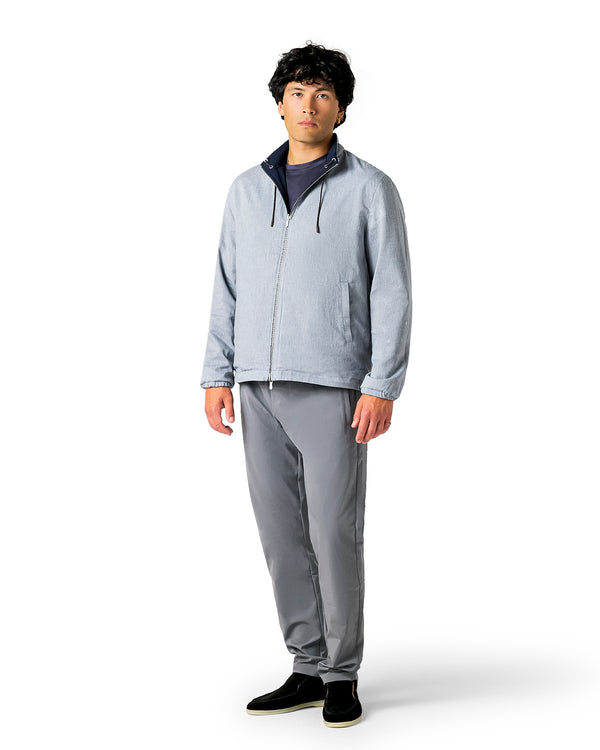 Man wearing a gray jacket and pants 