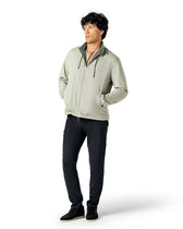 Man wearing a light gray jacket and dark pants