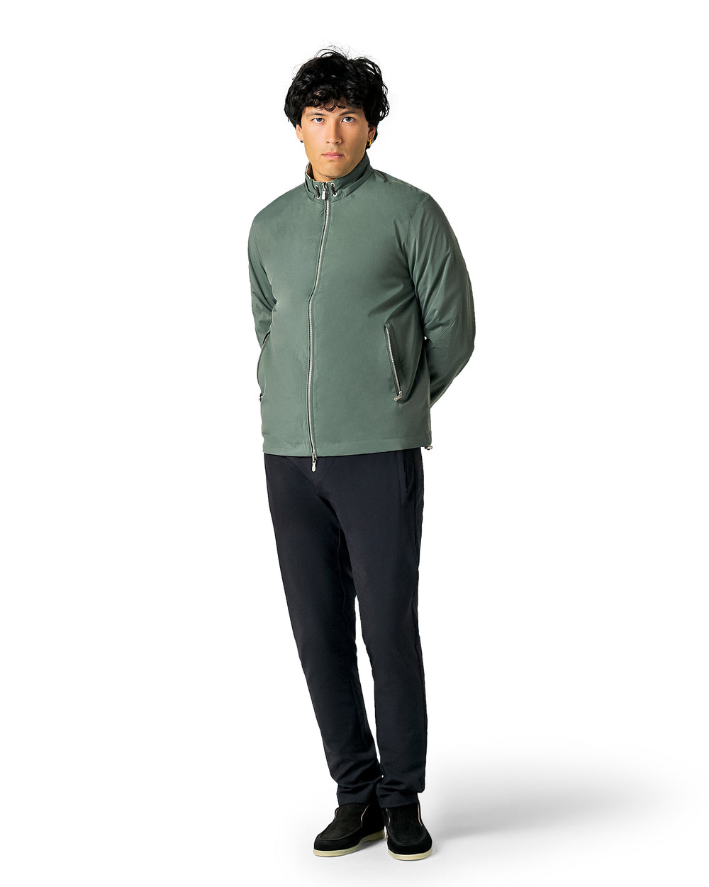 Man wearing a green jacket and black pants 