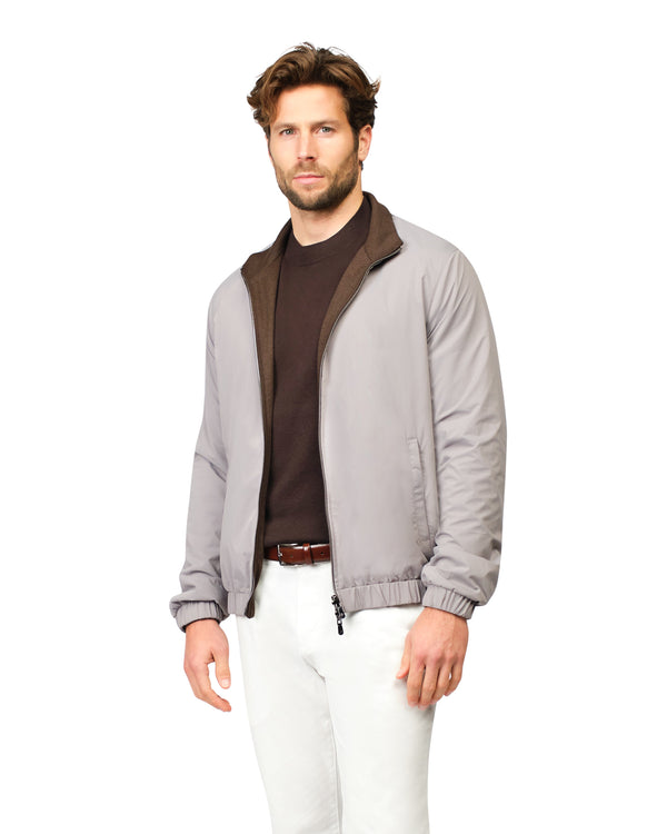 Man wearing a gray jacket with a brown collar