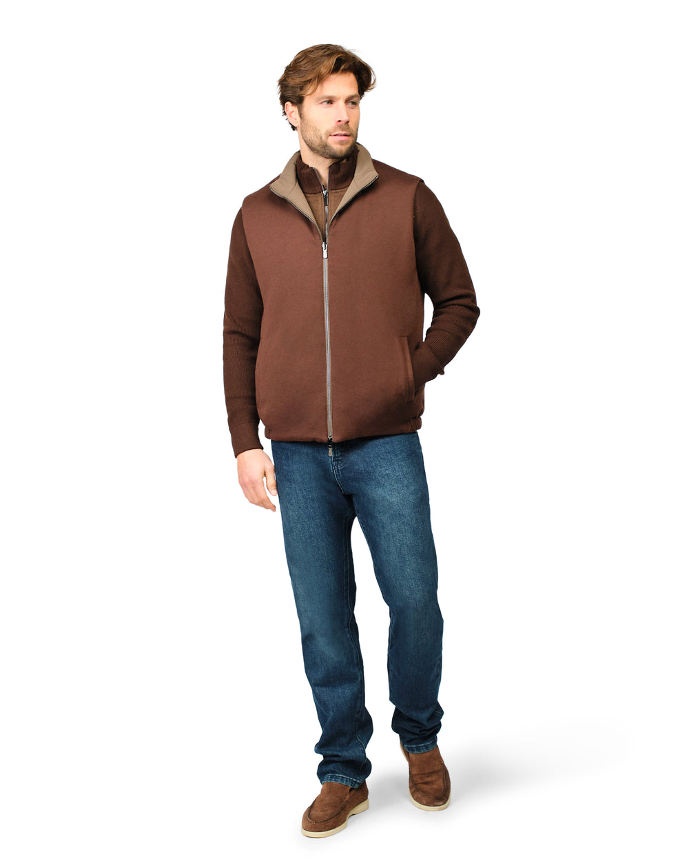 Man wearing a brown jacket and blue jeans on a white background