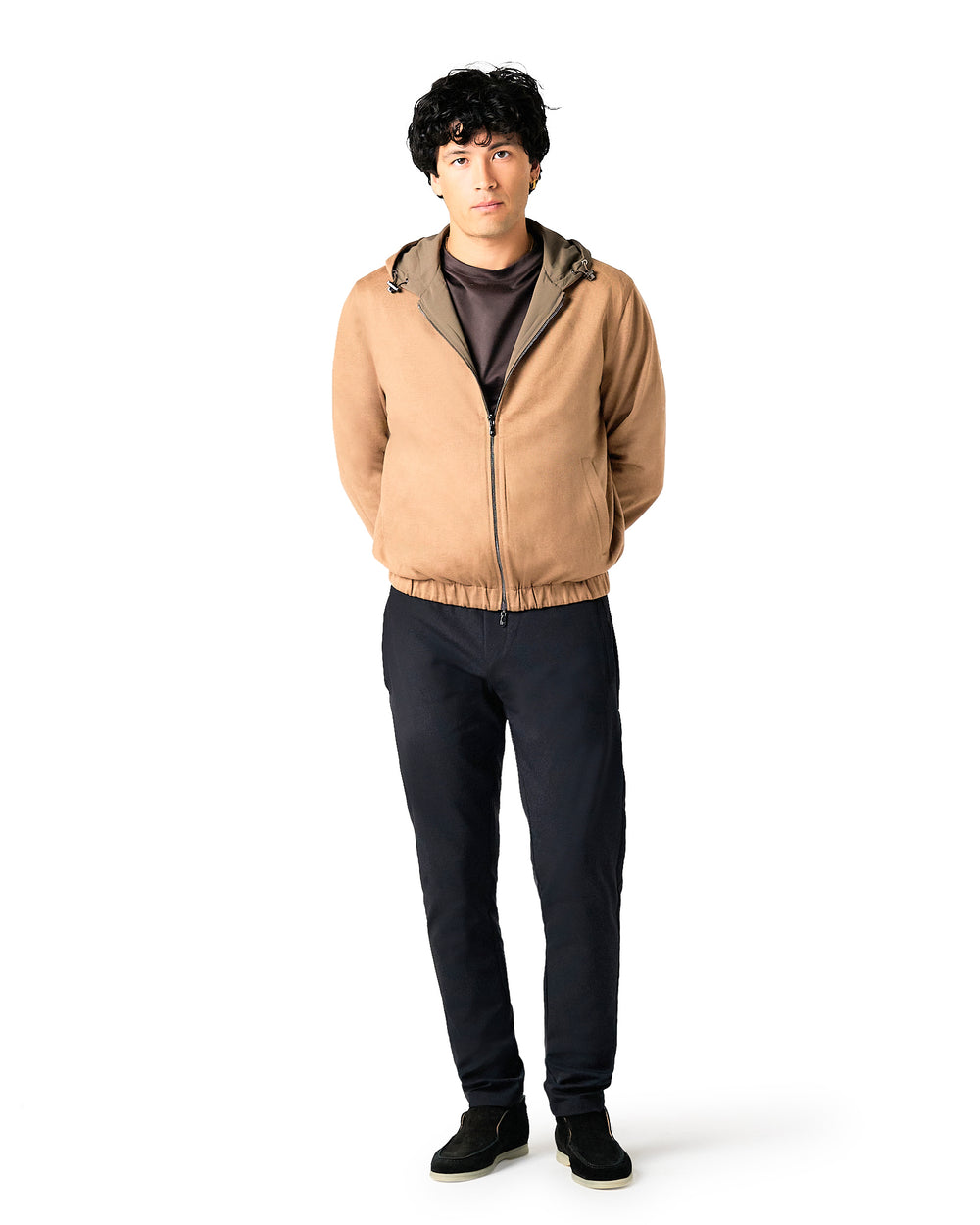 Man wearing a beige jacket and black pants 