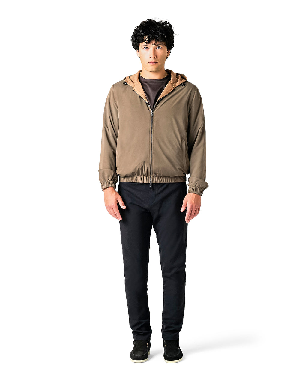 Man wearing a brown jacket and black pants 