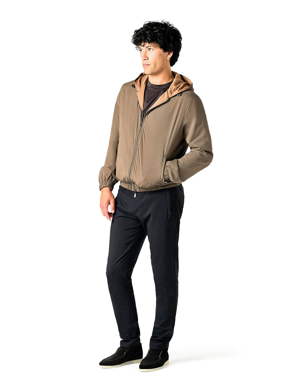 Man wearing a beige jacket and black pants 