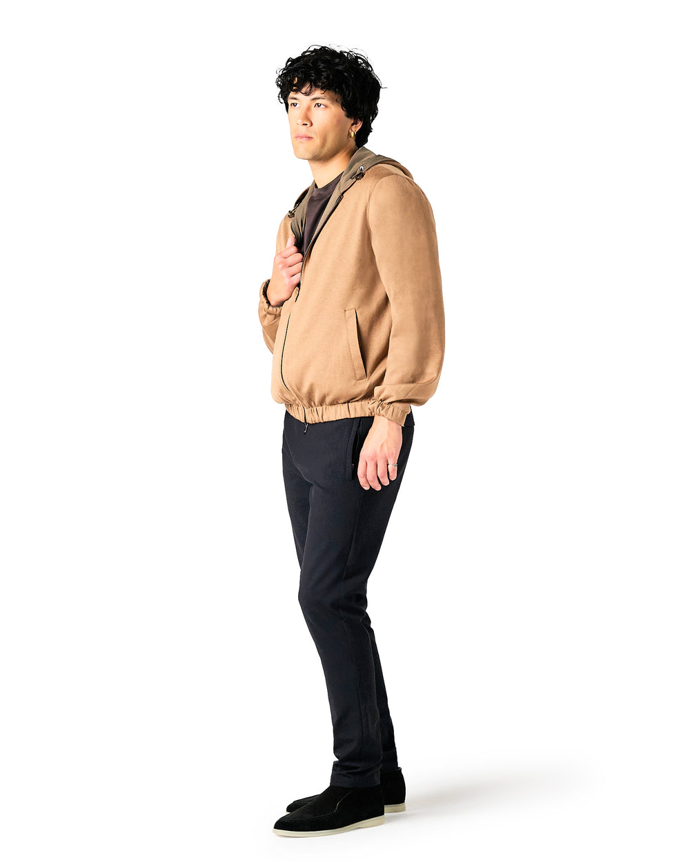 Man wearing a beige jacket and black pants