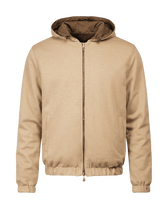 Beige jacket with a hood on a black background