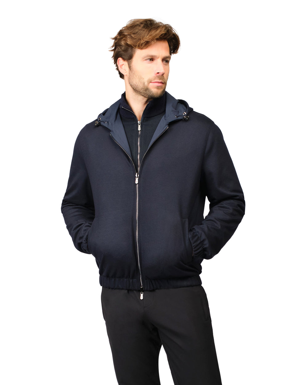 Man wearing a dark blue jacket with a hood on a white background