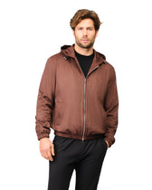 Man wearing a brown jacket on a white background