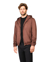 Man wearing a brown hooded jacket on a white background