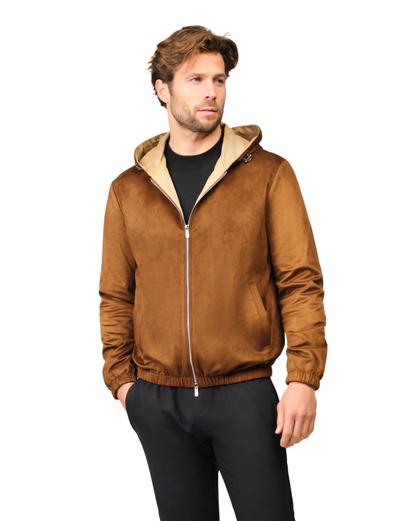 Man wearing a brown jacket with a beige hood on a white background