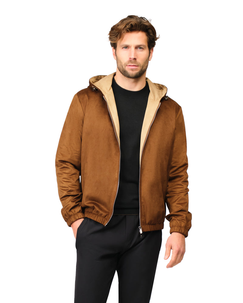 Man wearing a brown jacket with a beige hood on a white background