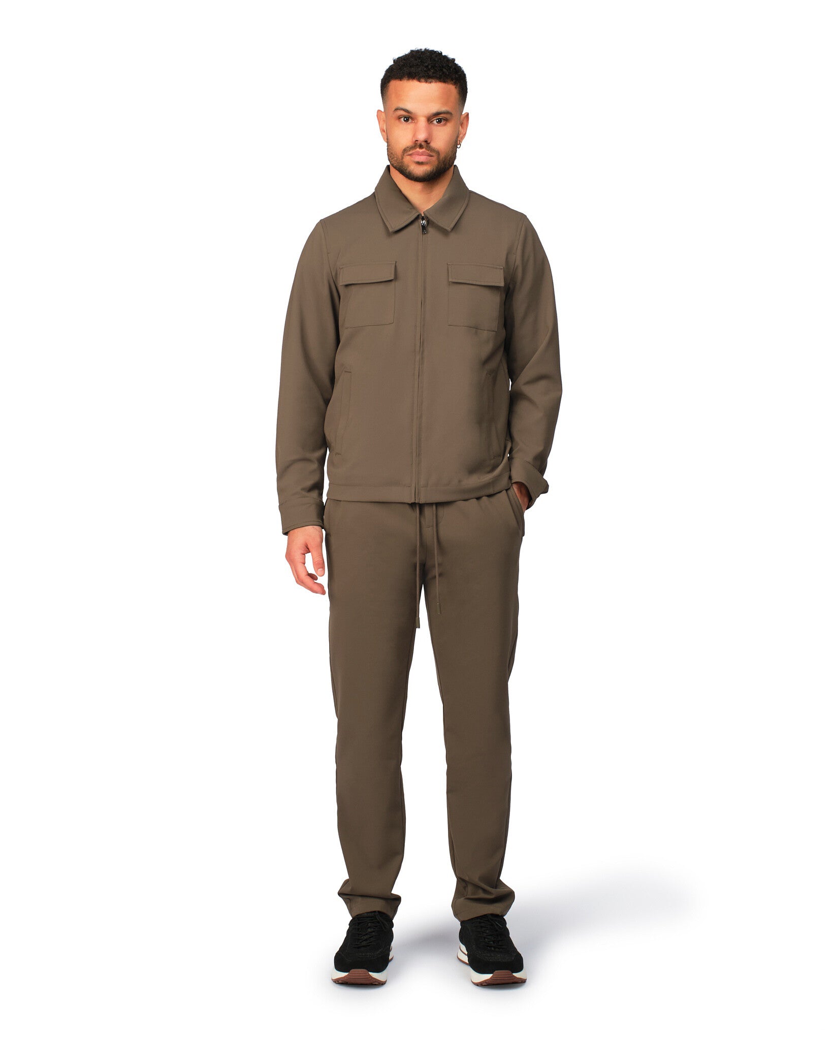 Man wearing a brown jumpsuit on a white background
