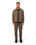 Man wearing a brown jacket and pants on a white background