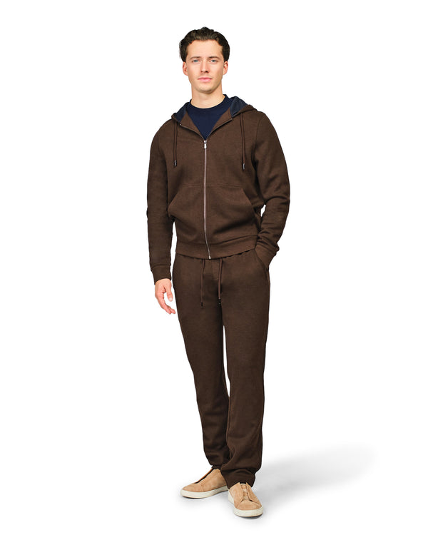 Man wearing a brown tracksuit on a white background