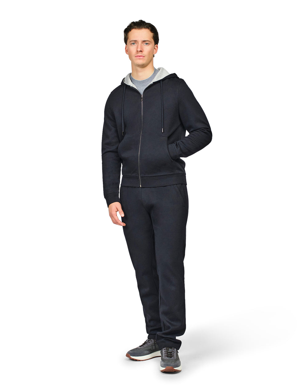 Man wearing a black tracksuit on a white background