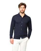 Man wearing a navy long-sleeve shirt with a collar on a white background