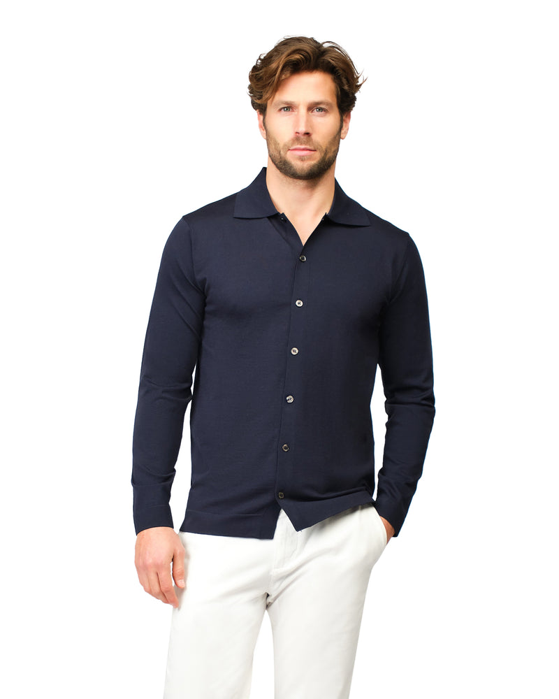 Man wearing a navy long-sleeve shirt with a collar on a white background