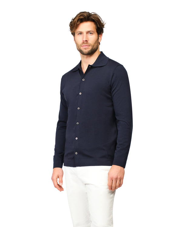 Man wearing a navy blue long-sleeve shirt with a collar on a white background