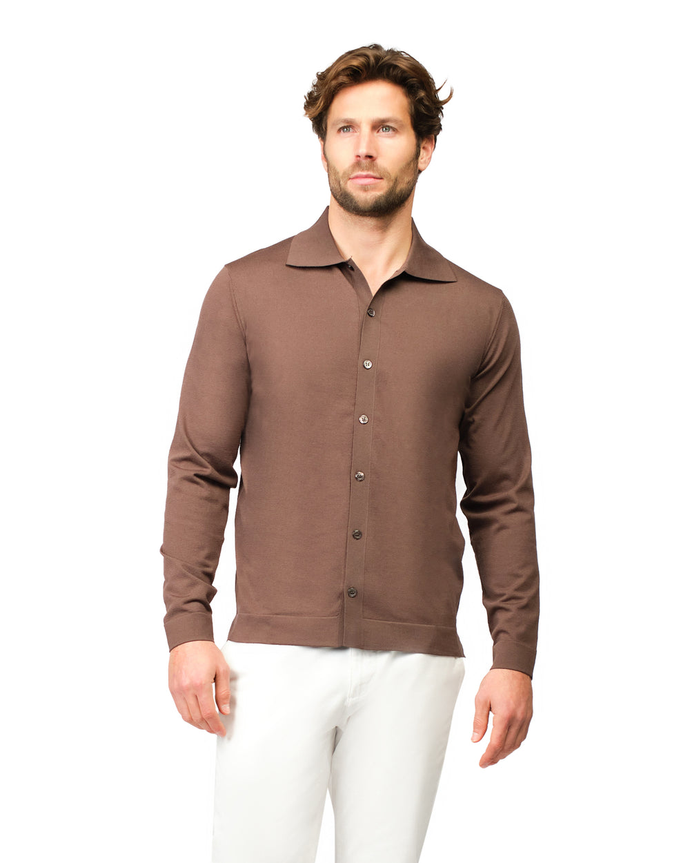 Man wearing a brown button-up shirt and white pants on a white background