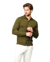 Man wearing a green shirt and white pants on a white background