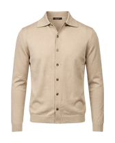 Beige cardigan with button details on a black background