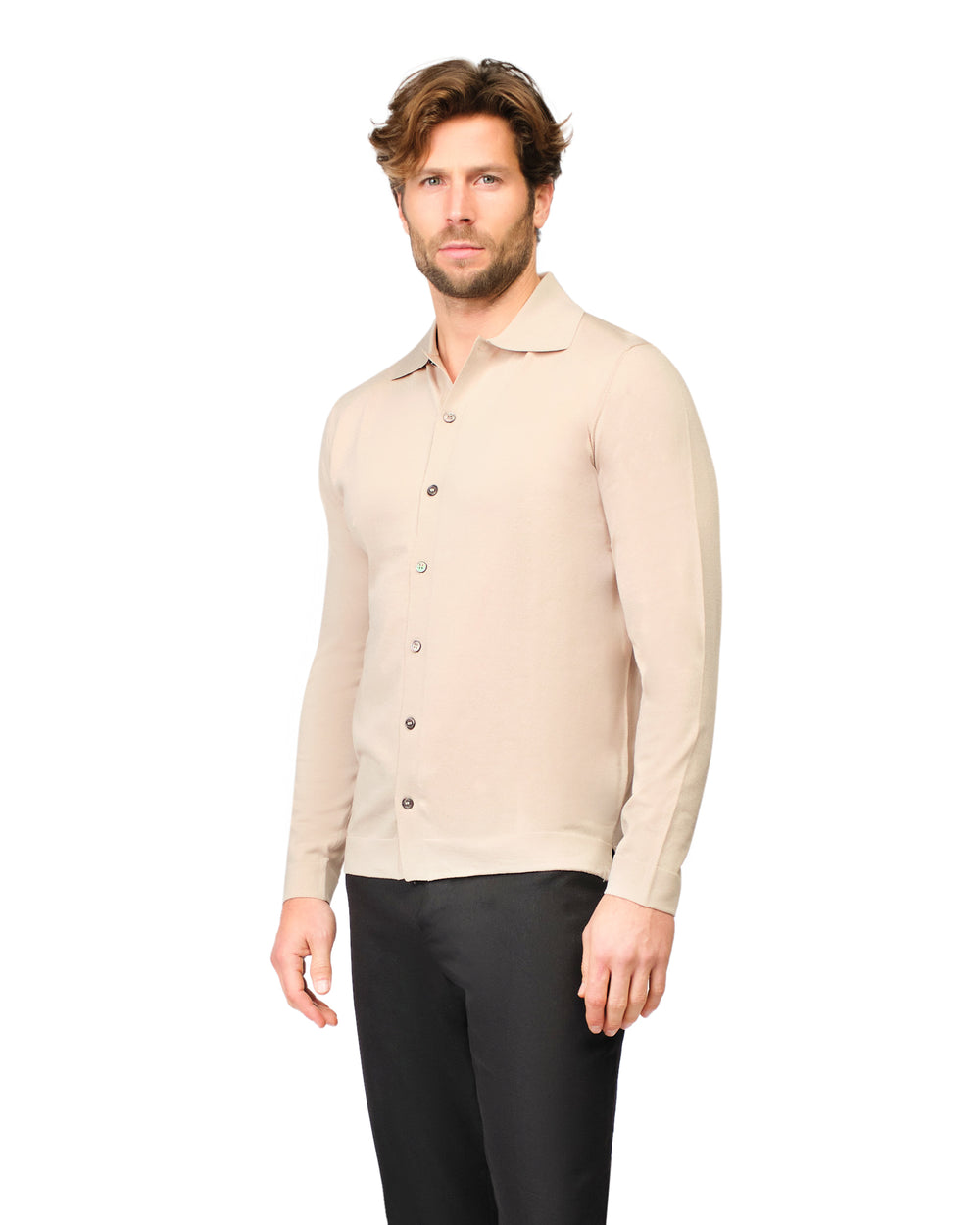 Man wearing a beige button-up shirt and black pants on a white background