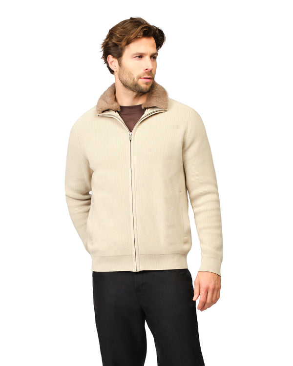 Man wearing a beige zip-up jacket with a brown collar on a white background