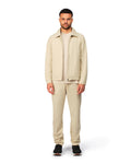 Beige tech jacket with sleek design and zip closure, angled product view showing fit and details.
