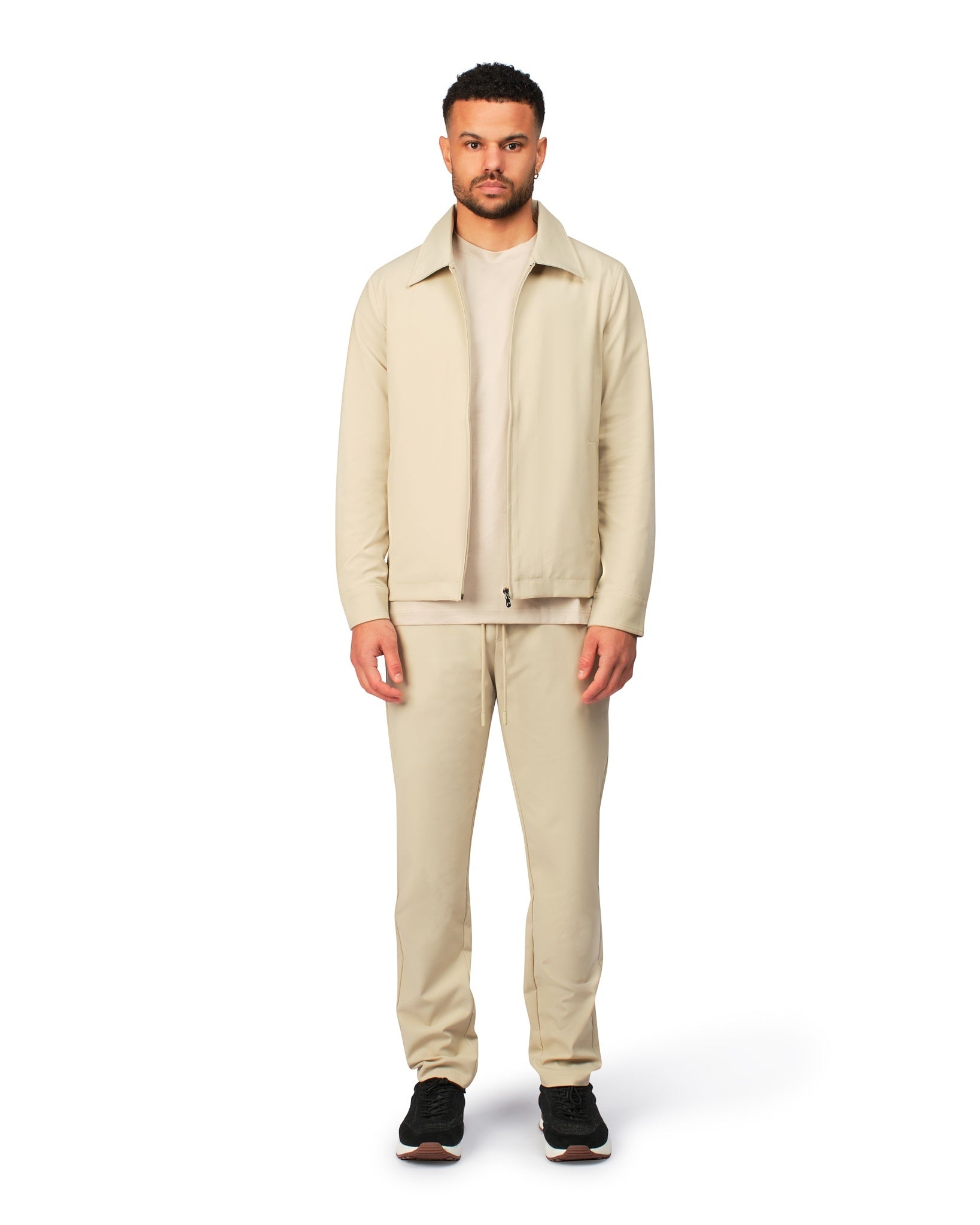 Beige tech jacket with sleek design and zip closure, angled product view showing fit and details.
