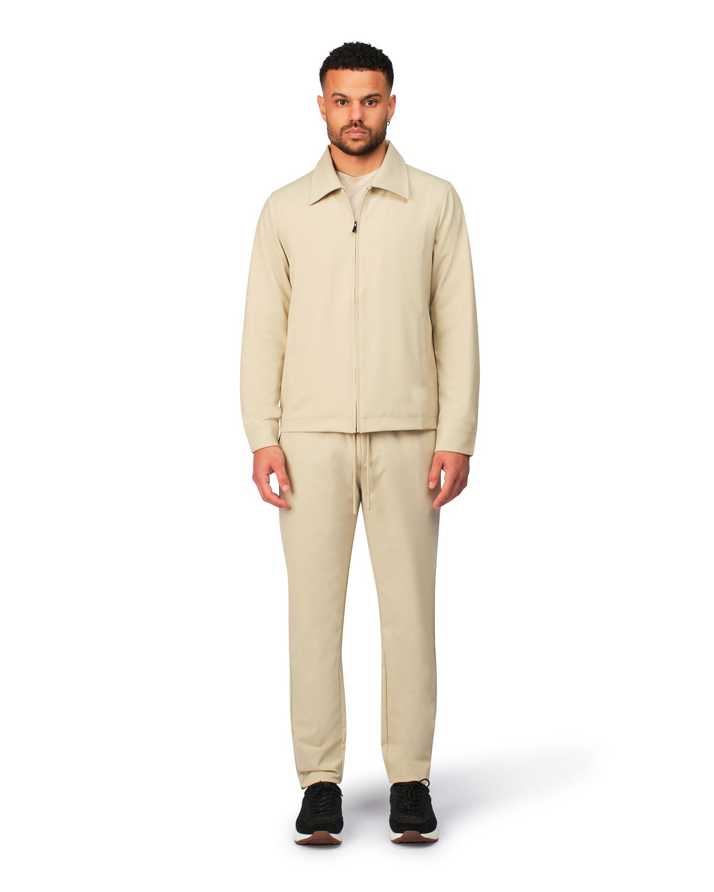 Beige tech jacket with sleek design and zip closure, angled product view showing fit and details.
