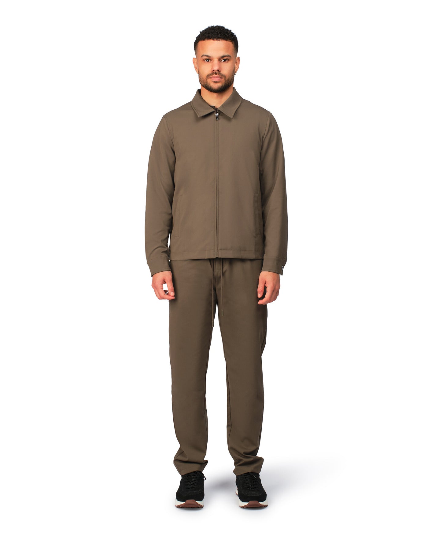 Man wearing a brown outfit on a white background