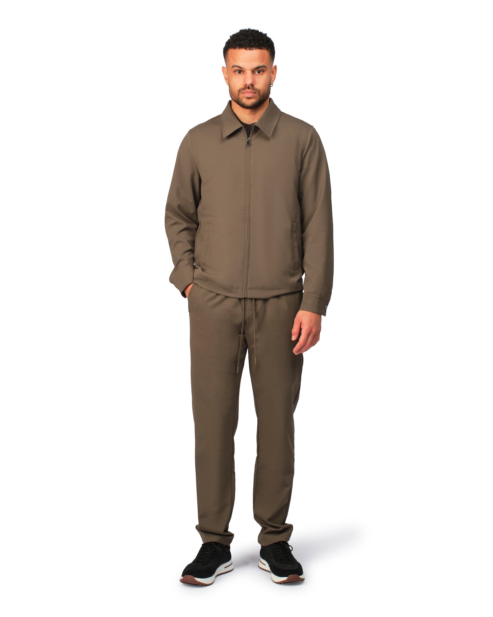 Man wearing a brown outfit on a white background