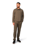 Man wearing a brown jacket and pants on a white background