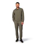 Green tech jacket with modern techwear design, close-up view highlighting fabric and stitching details.