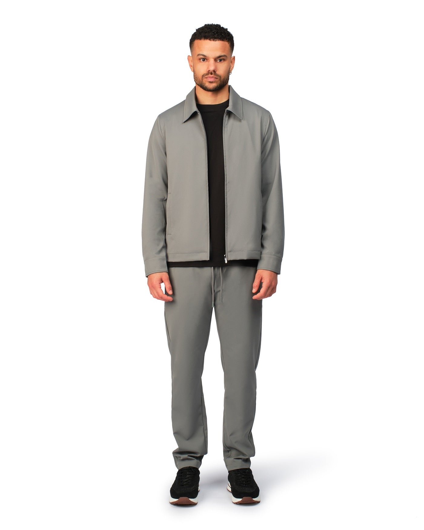 Grey tech jacket with sleek design and zip closure, angled product view showing fit and details.