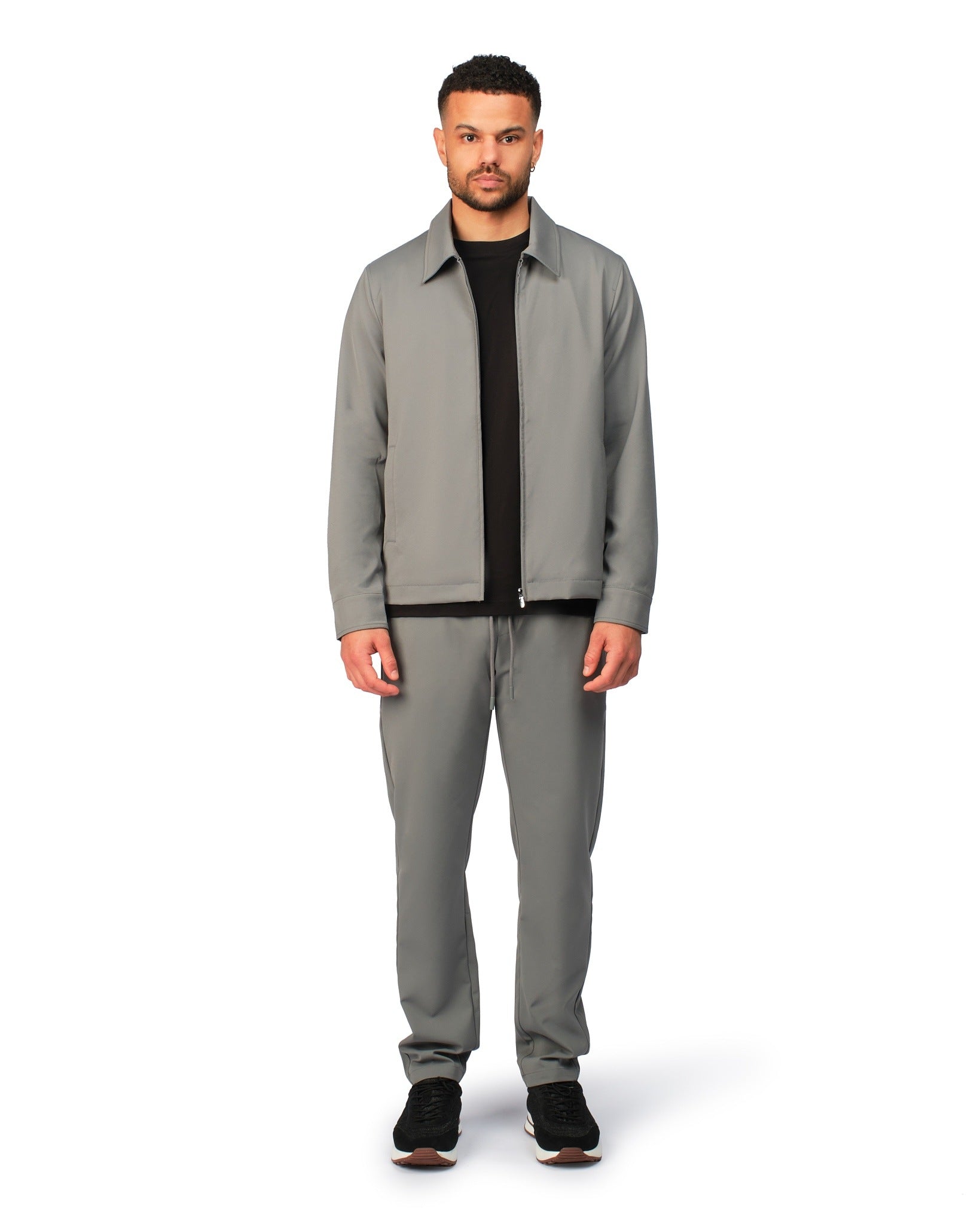 Grey tech jacket with sleek design and zip closure, angled product view showing fit and details.