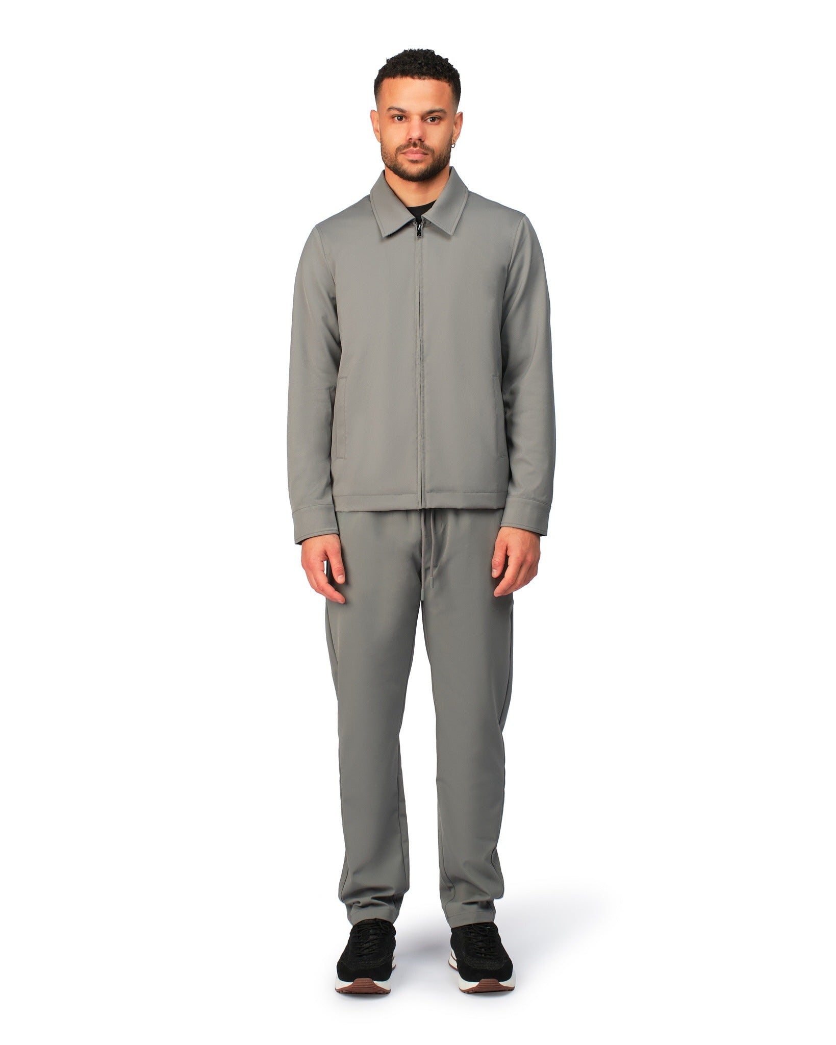 Grey tech jacket with sleek design and zip closure, angled product view showing fit and details.
