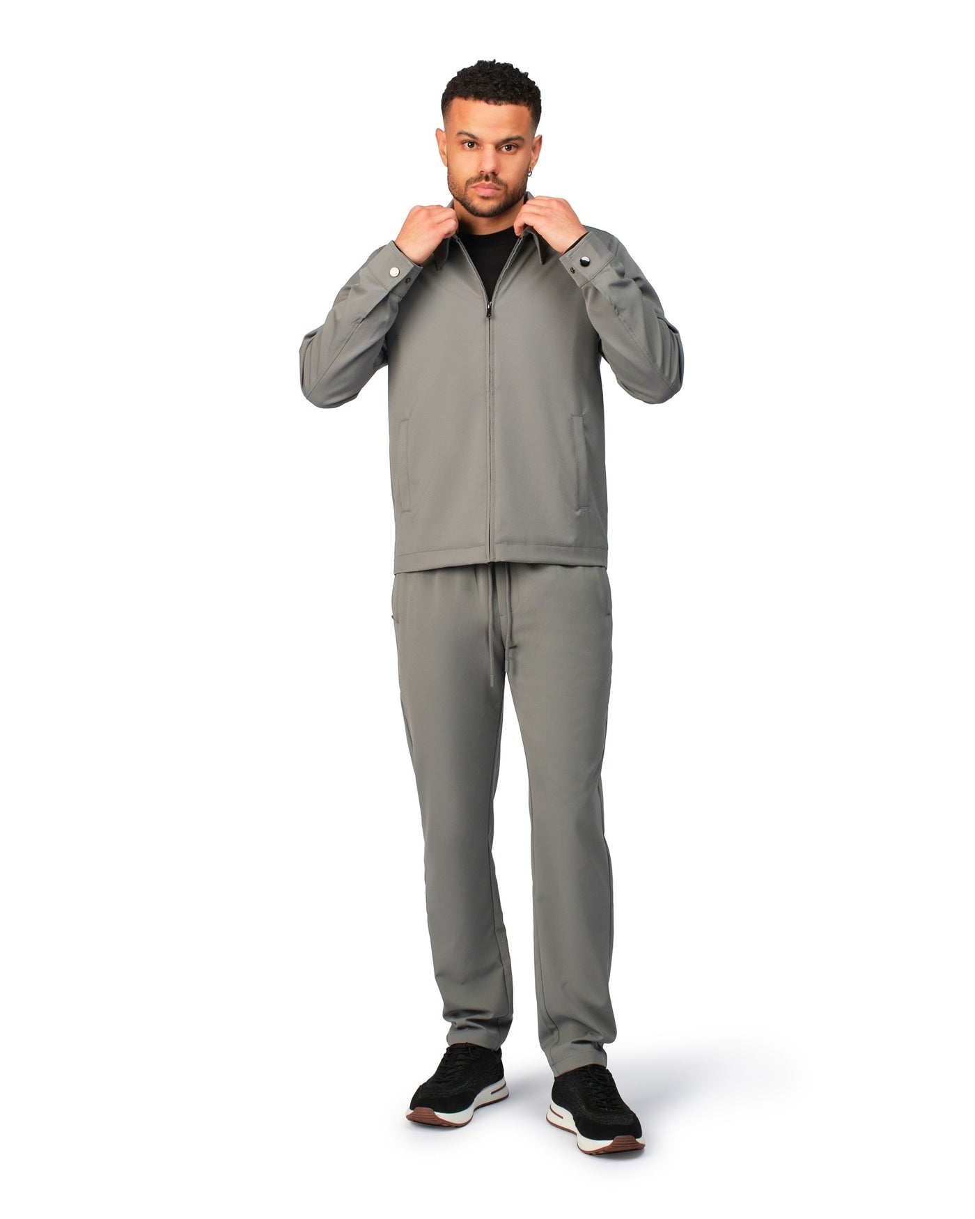 Grey tech jacket with modern techwear design, close-up view highlighting fabric and stitching details.