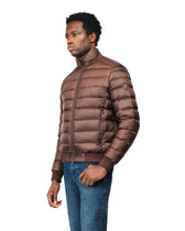 Man wearing a brown puffer jacket on a white background