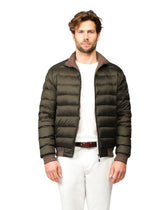 Man wearing a green puffer jacket on a white background