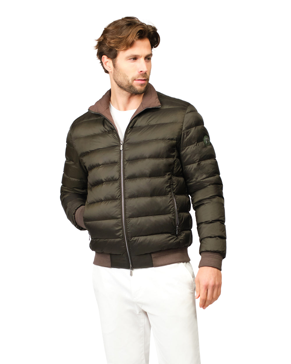Man wearing a green puffer jacket on a white background